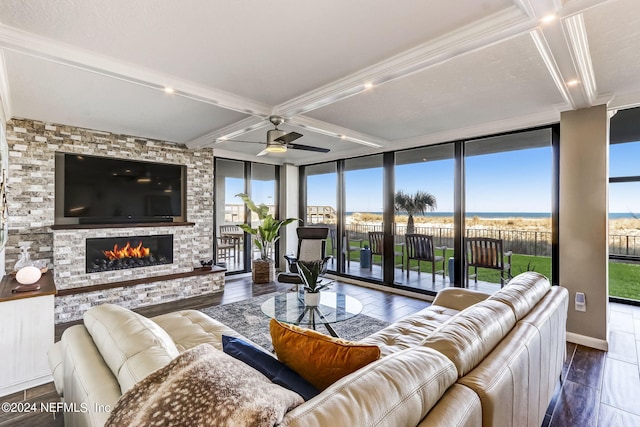 living area featuring a stone fireplace, dark wood-type flooring, and coffered ceiling