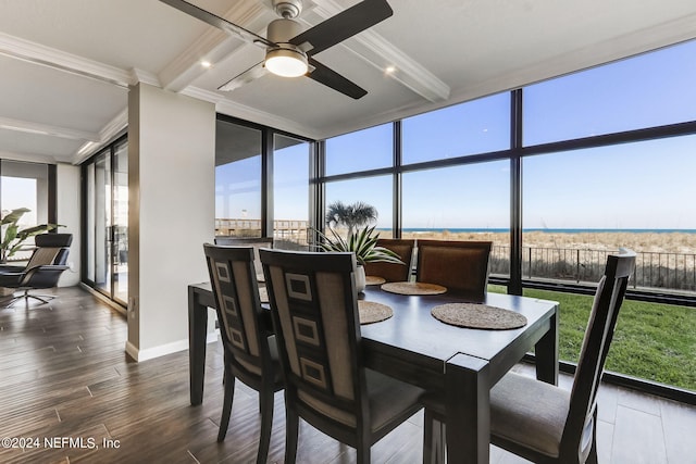 sunroom / solarium featuring ceiling fan and a water view