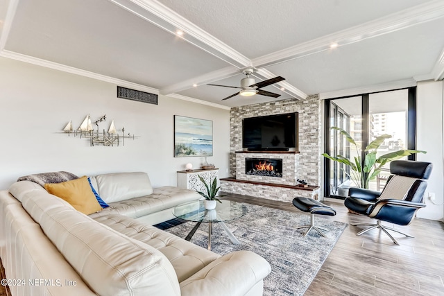 living room featuring light wood-type flooring, visible vents, and crown molding