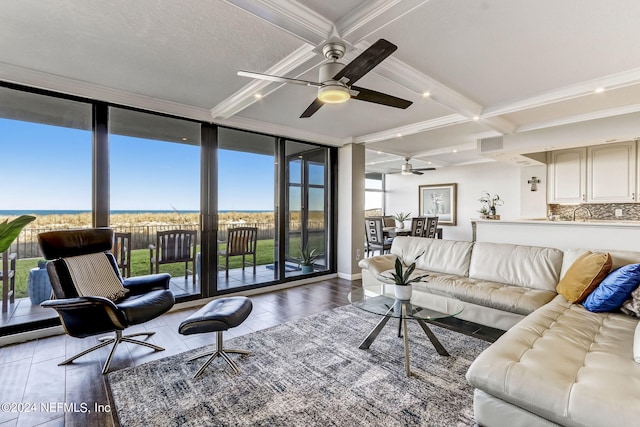 living room with crown molding, floor to ceiling windows, coffered ceiling, and beam ceiling