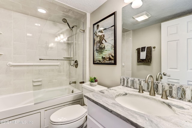 full bath with toilet, vanity, a textured ceiling, and bathing tub / shower combination