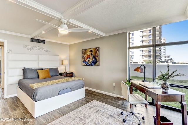 bedroom with baseboards, ornamental molding, and wood finish floors