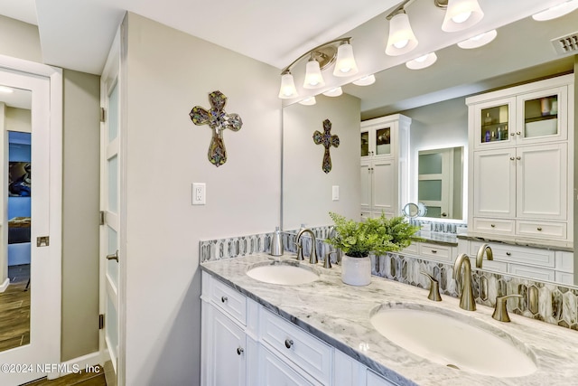 full bath with visible vents, a sink, and double vanity