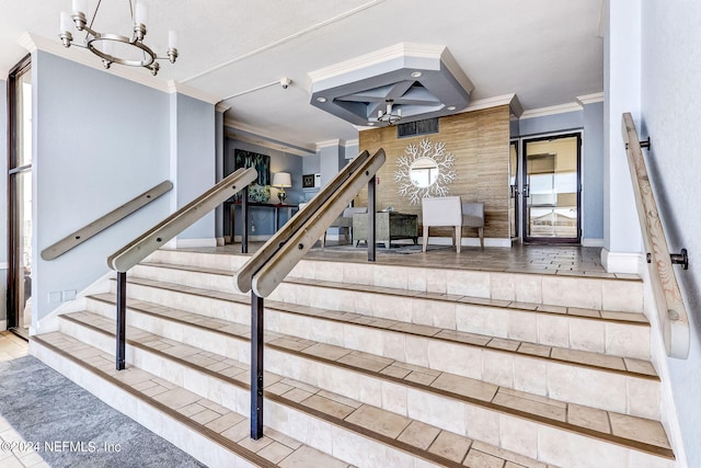 stairs featuring ornamental molding and a chandelier