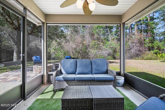 sunroom / solarium featuring a healthy amount of sunlight and a ceiling fan