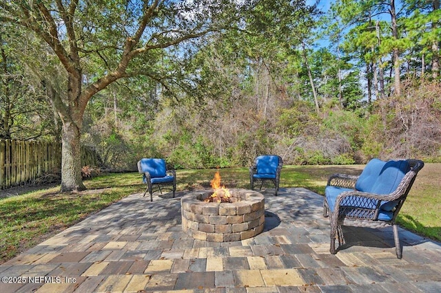 view of patio / terrace featuring fence and a fire pit