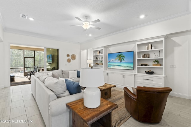 living room with a textured ceiling, visible vents, baseboards, a ceiling fan, and ornamental molding