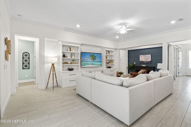 living area featuring a ceiling fan, recessed lighting, crown molding, and baseboards