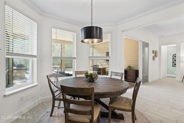 dining space featuring ornamental molding, wood finish floors, and baseboards