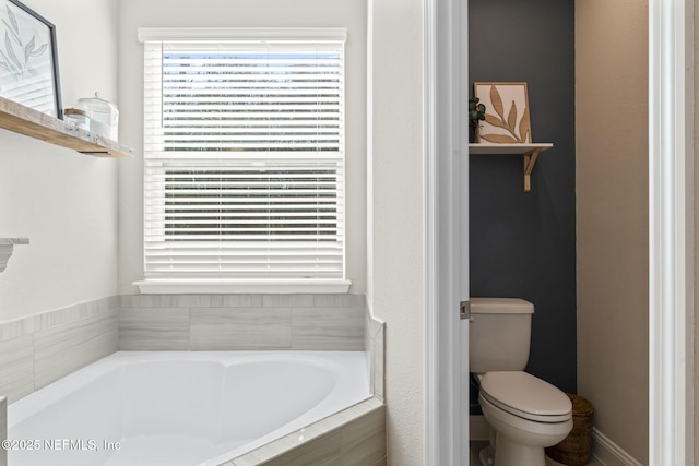 bathroom featuring toilet and a bath