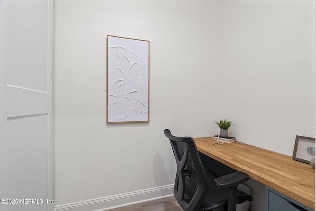 home office featuring baseboards and dark wood finished floors