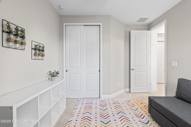 sitting room with visible vents and baseboards