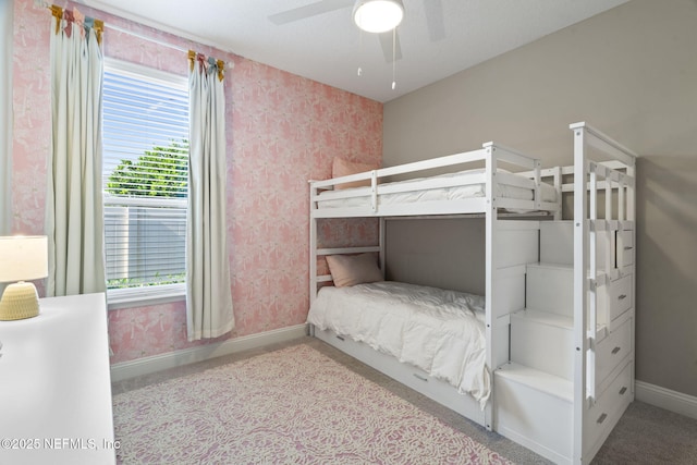 unfurnished bedroom featuring wallpapered walls, ceiling fan, baseboards, and carpet flooring