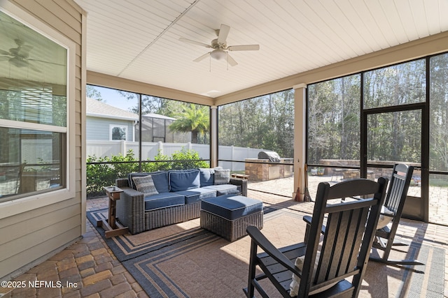 sunroom featuring a ceiling fan