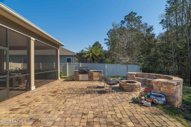 view of patio with fence and a fire pit