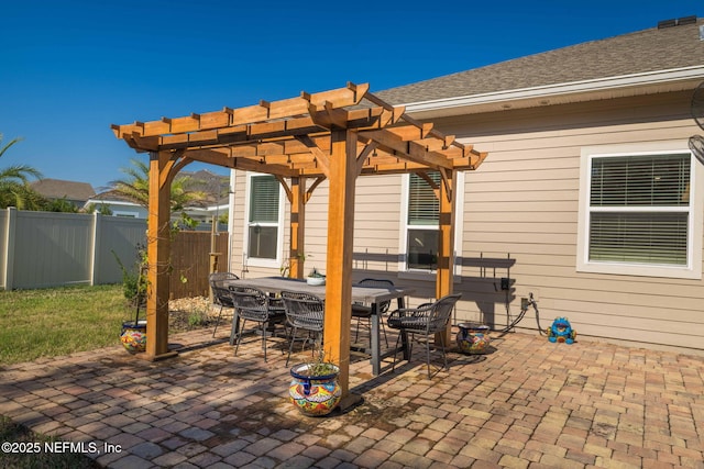 view of patio / terrace with outdoor dining area, fence, and a pergola