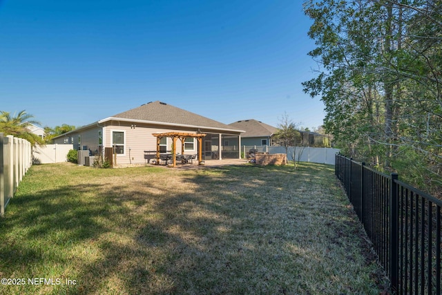 back of house with a fenced backyard, a yard, a patio, and a pergola