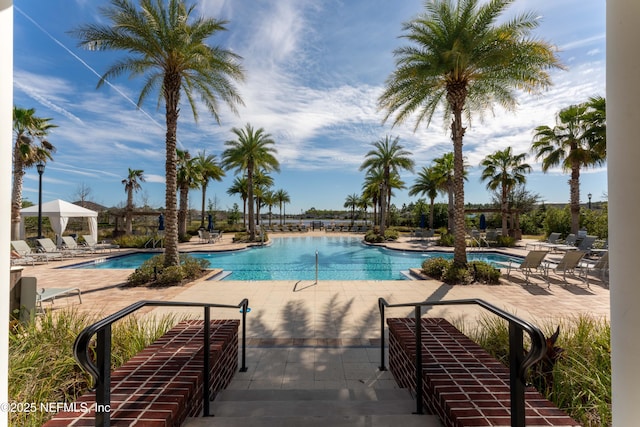 pool with a patio and a gazebo