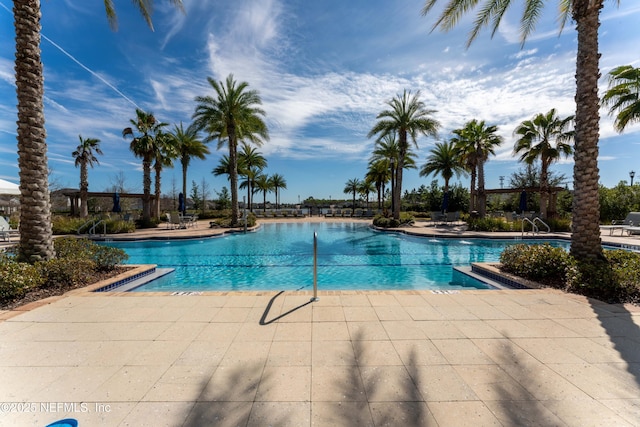 community pool with a patio area