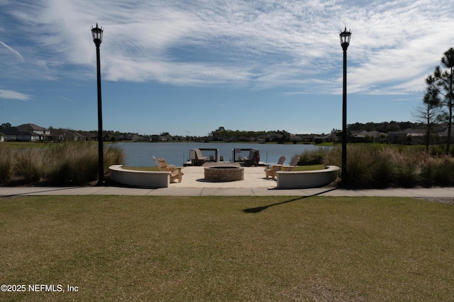 view of patio featuring an outdoor fire pit and a water view