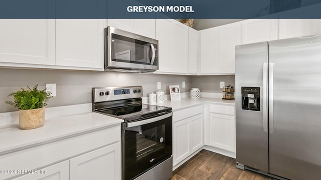 kitchen with dark wood finished floors, white cabinetry, stainless steel appliances, and light countertops