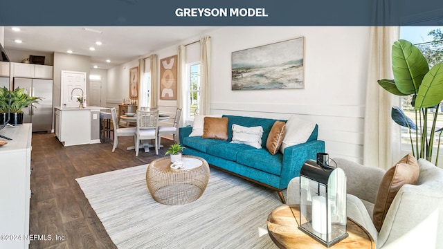 living room with dark wood-type flooring and recessed lighting