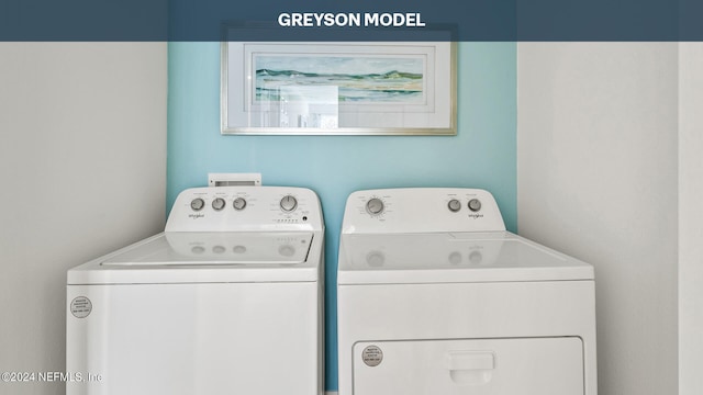 clothes washing area with laundry area and washer and clothes dryer