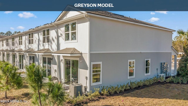 view of side of home with cooling unit and stucco siding