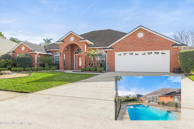 view of front of property featuring a fenced in pool, an attached garage, fence, a front lawn, and brick siding