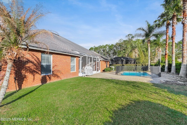 view of yard with a fenced in pool, a patio area, glass enclosure, and fence