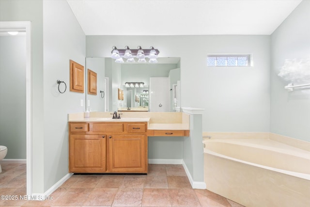 full bath featuring toilet, vanity, a bath, and baseboards