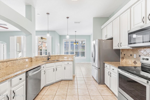 kitchen with appliances with stainless steel finishes, visible vents, a sink, and a ceiling fan