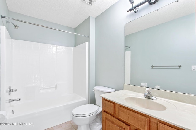 full bath featuring shower / bathtub combination, toilet, vanity, a textured ceiling, and tile patterned flooring