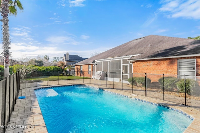 view of pool with a sunroom, a patio area, fence, and a fenced in pool