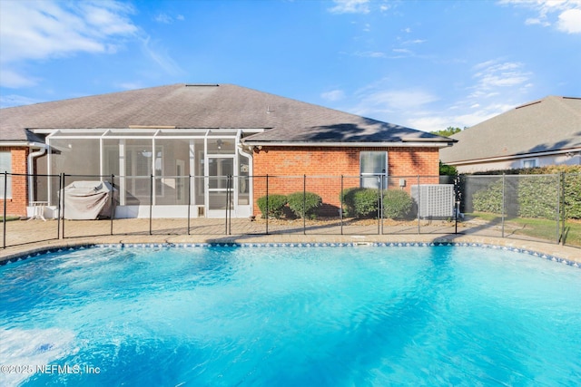 view of swimming pool with fence, a fenced in pool, and a lanai