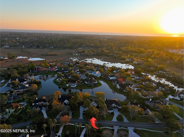 drone / aerial view featuring a water view and a residential view