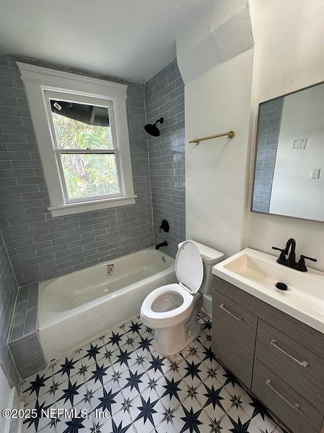 full bathroom featuring toilet, vanity, and washtub / shower combination