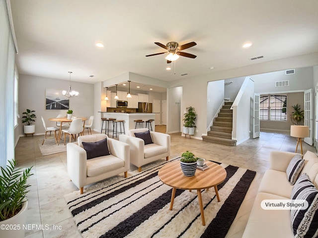 living room with stairs, visible vents, and recessed lighting