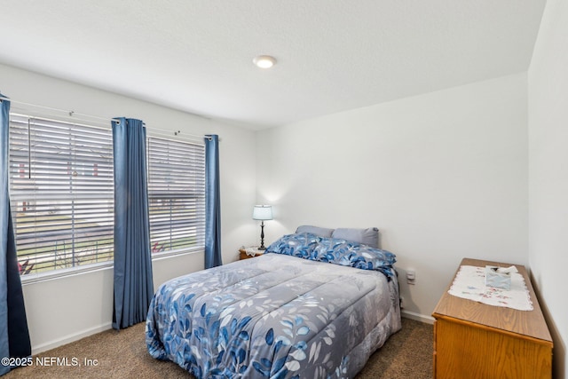 carpeted bedroom featuring baseboards