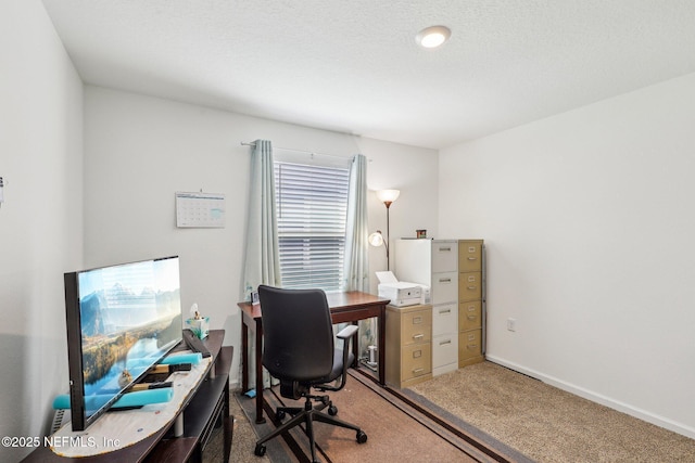 carpeted home office featuring baseboards