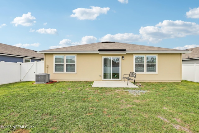 rear view of house featuring stucco siding, a fenced backyard, a patio, and a yard