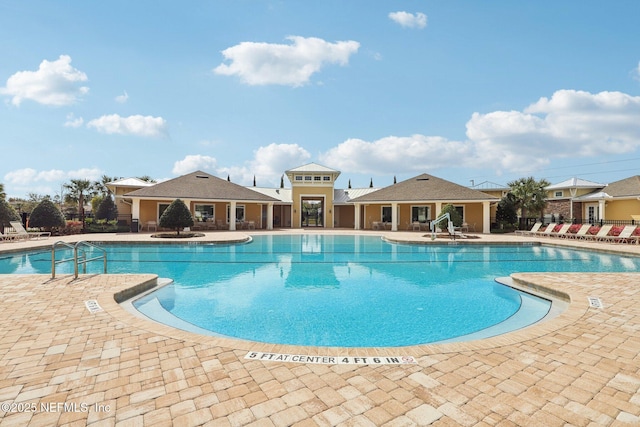 pool featuring fence and a patio