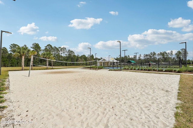 view of property's community with fence and volleyball court