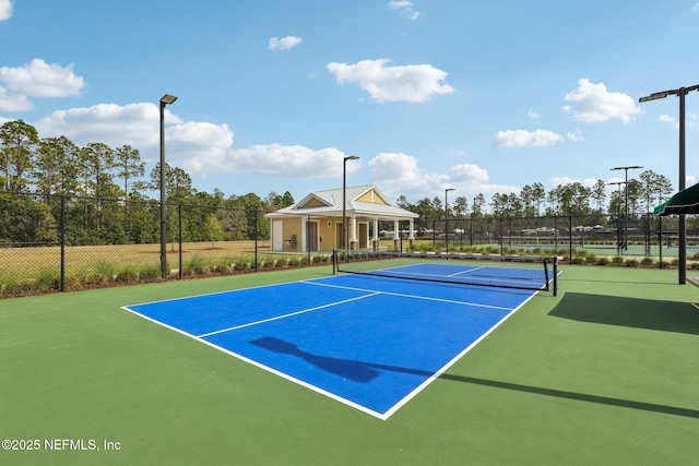 view of tennis court with fence