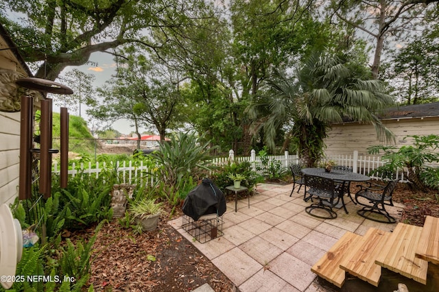 view of patio with outdoor dining area and fence