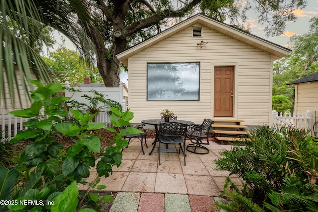 exterior space featuring entry steps and fence