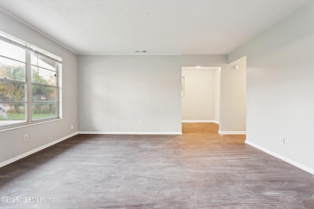 spare room with visible vents and baseboards