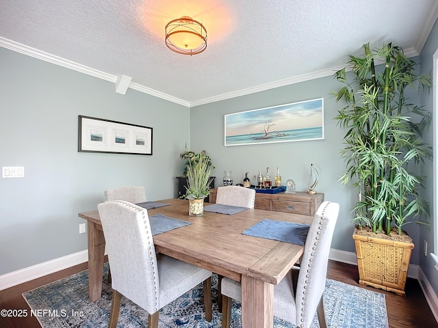 dining space featuring crown molding, dark wood-style floors, baseboards, and a textured ceiling