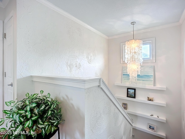 stairway featuring ornamental molding and an inviting chandelier