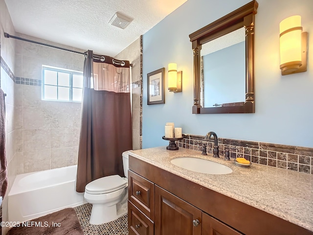 bathroom featuring visible vents, toilet, vanity, shower / bath combination with curtain, and a textured ceiling